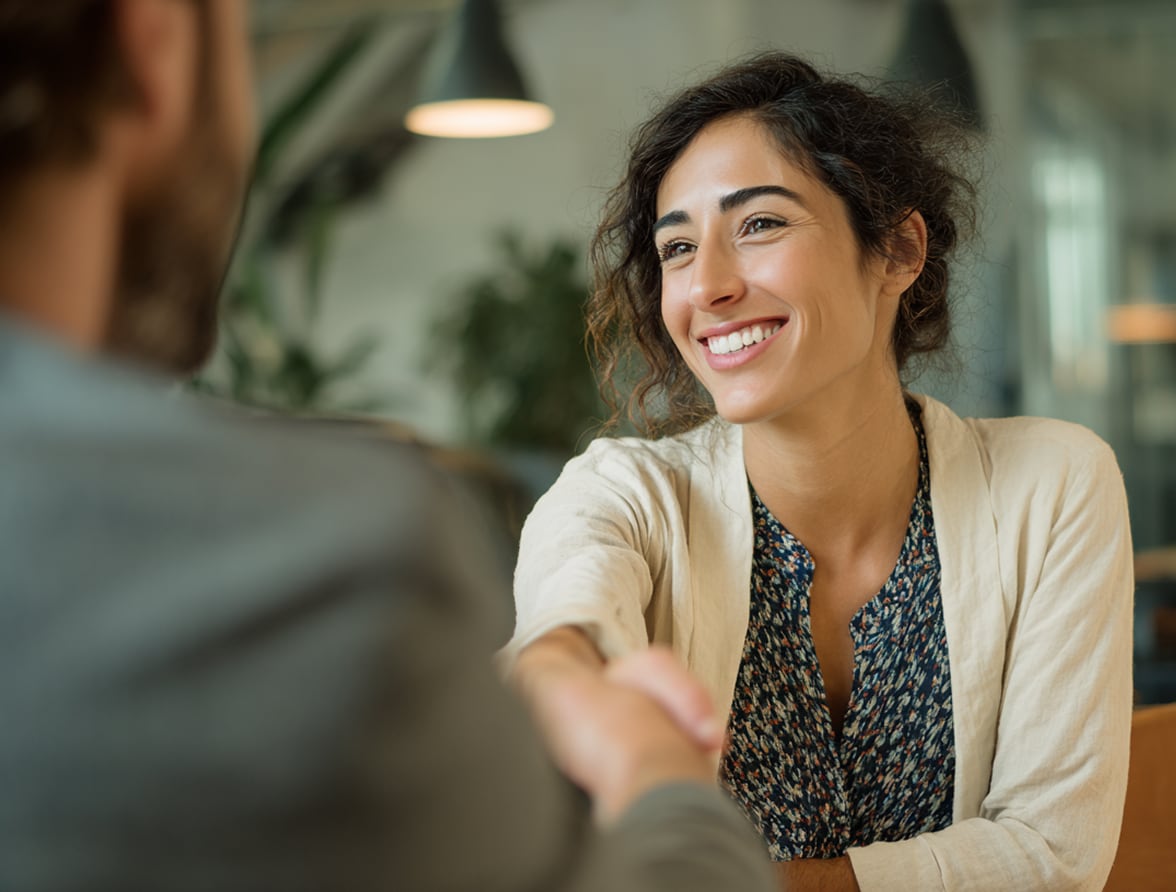 Professional consultation meeting with client shaking hands in office